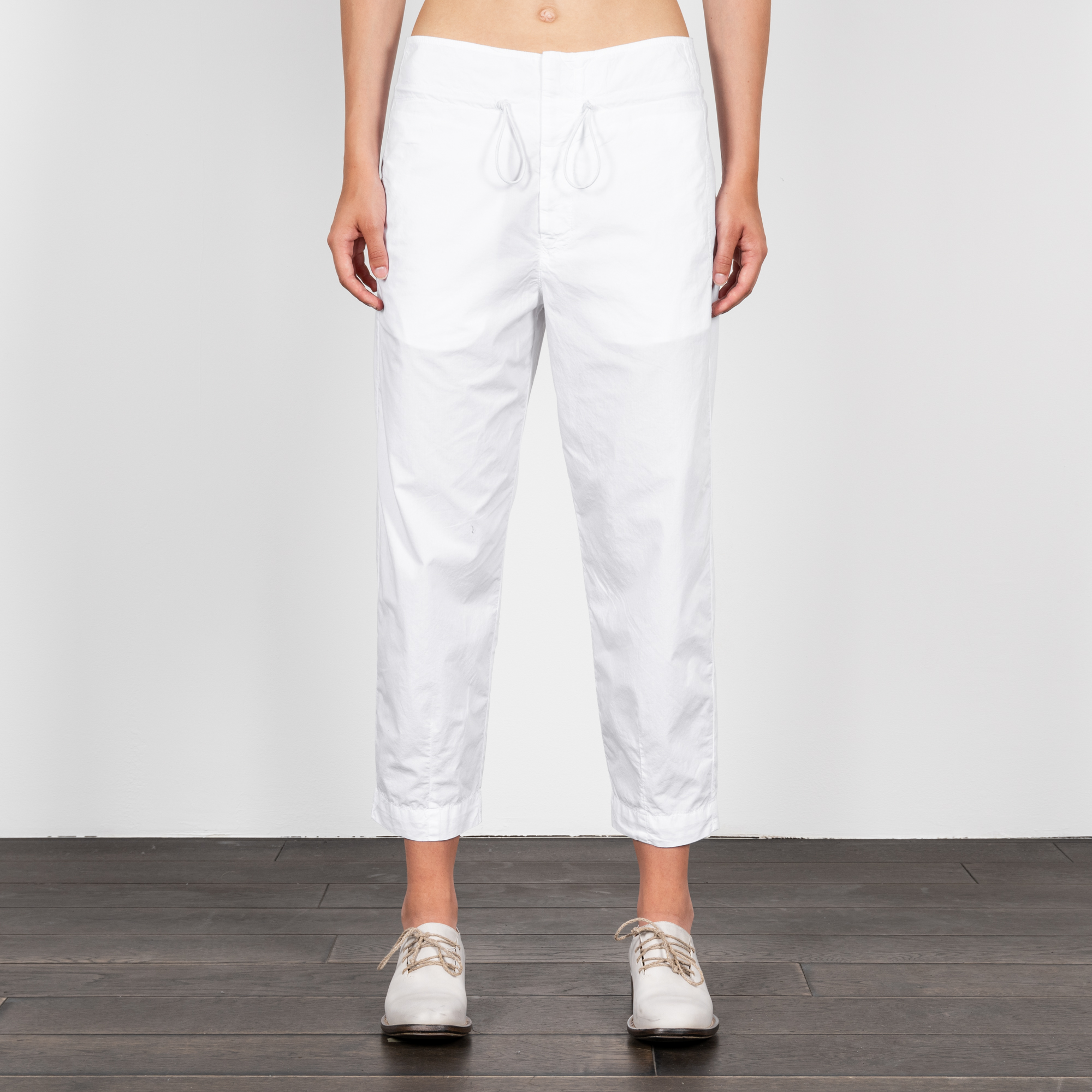 Woman wearing white cotton drawstring pants